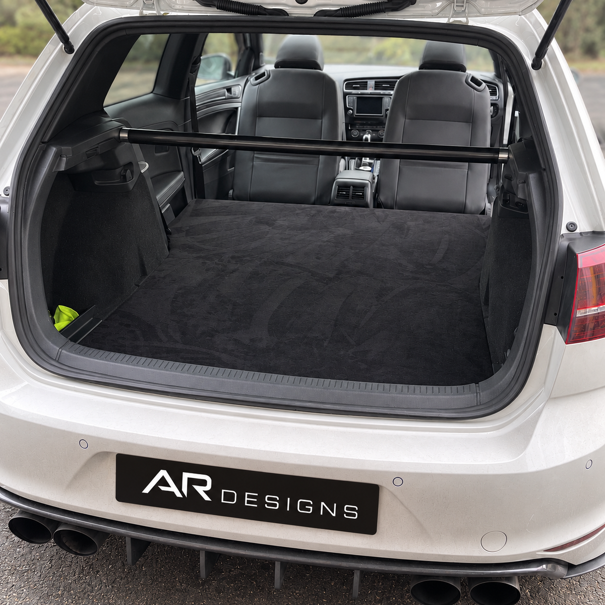VW Golf rear seat delete with continuous upholstered floor and AR Designs plate; photo edited to show the floor without access hatches.